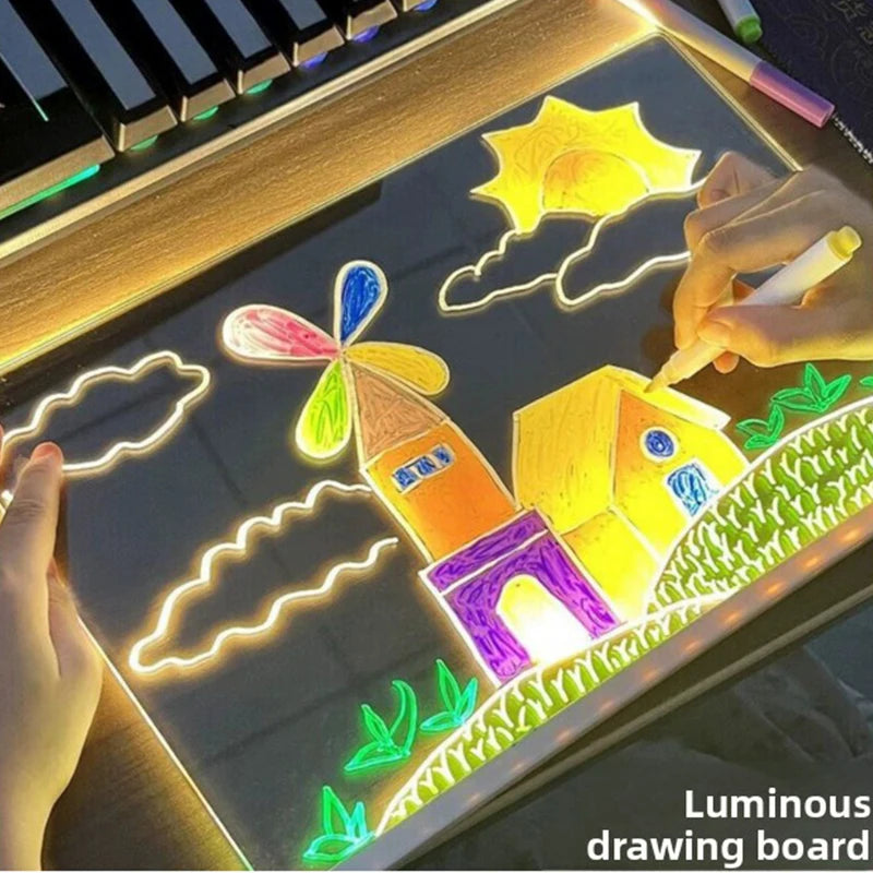 Hands drawing a windmill scene on the luminous GlowBoard drawing board