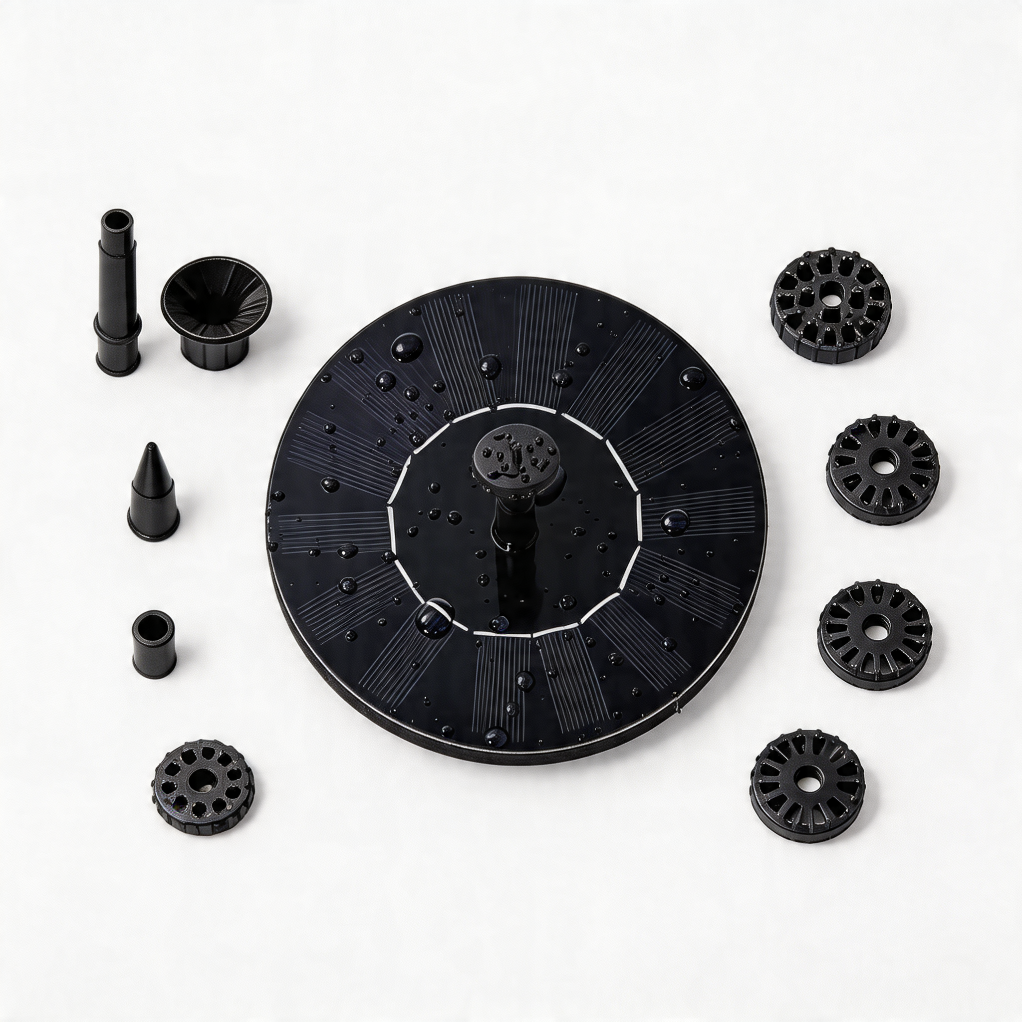 Flat lay of the SplashJet solar fountain disc surrounded by nozzle attachments on a white background